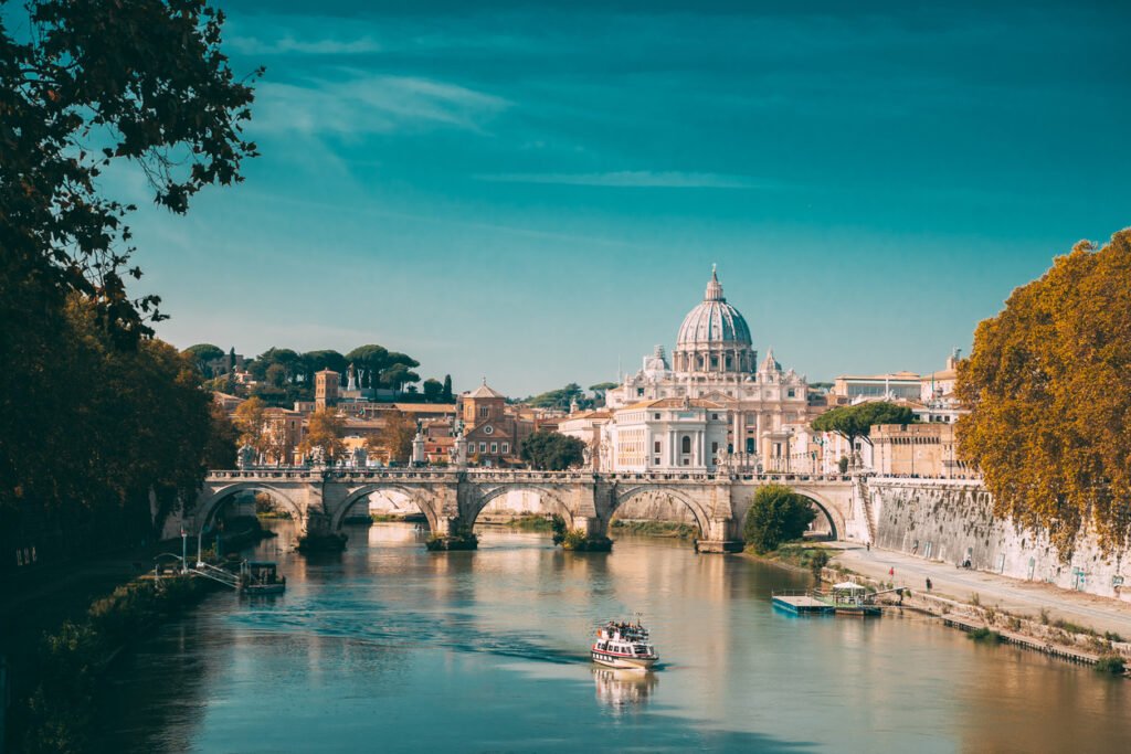 Rome, Italy. Papal Basilica Of St. Peter In The Vatican. Sightseeing Boat Floating Near Aelian Bridge. Touristic Boat